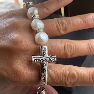 Cross Bracelet with silver and pearl colored beads. Stretch band.